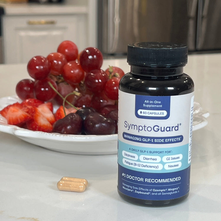 Symptoguard bottle and two pill capsules on a kitchen counter.